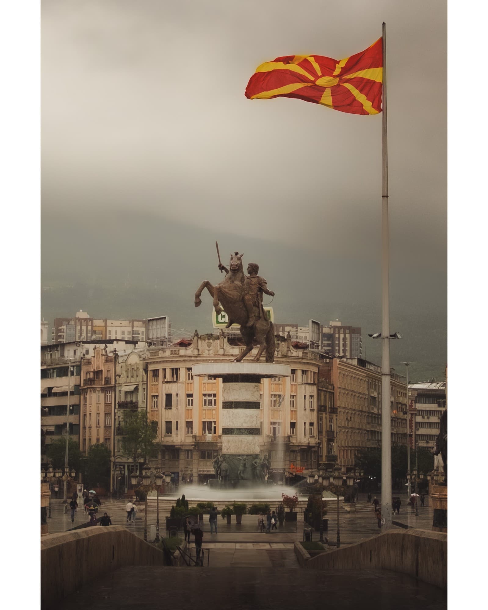 Alexander the Great statue and fountain in Skopje's main square, North Macedonia flag flying